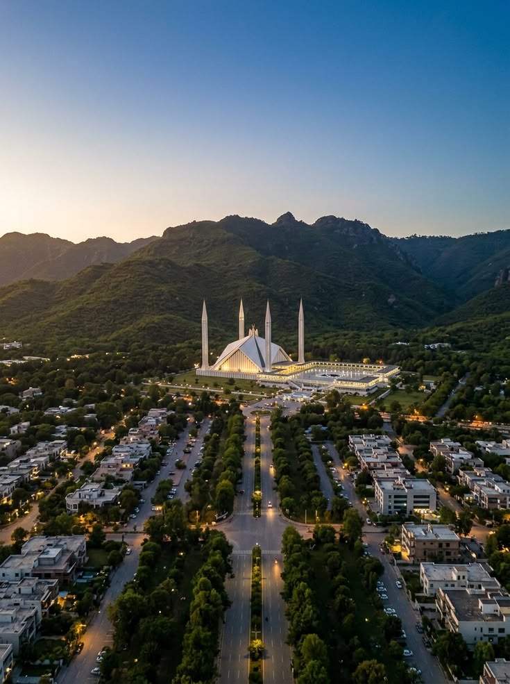 The Islamabad skyline at dusk with the Margalla Hills behind it